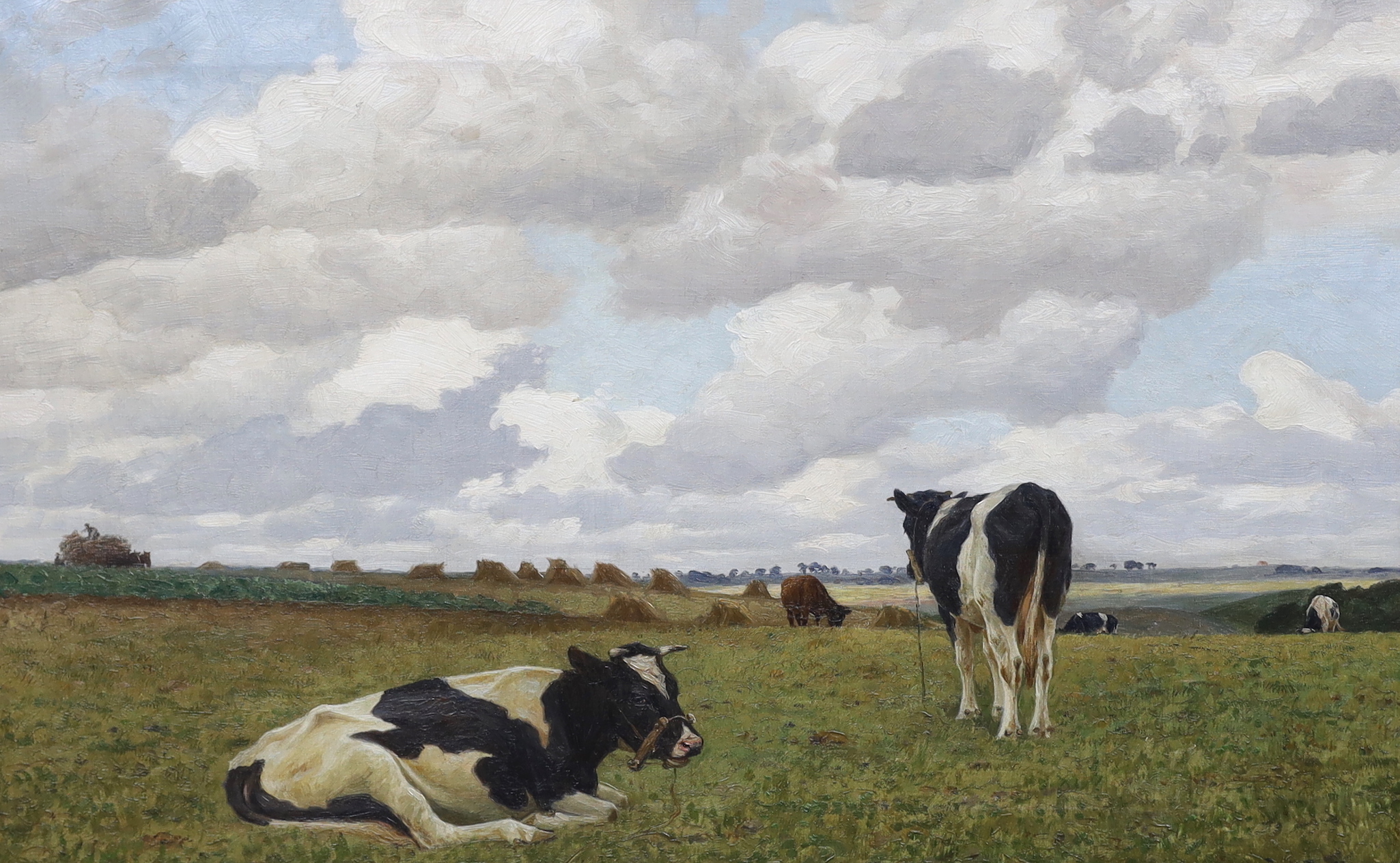Poul Steffensen (1866-1923), oil on canvas, Cattle grazing before hayricks, signed and indistinctly dated, 63 x 102cm